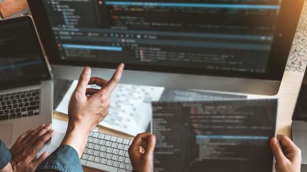 Developing programmer Team Development Website design and coding technologies working in software company office